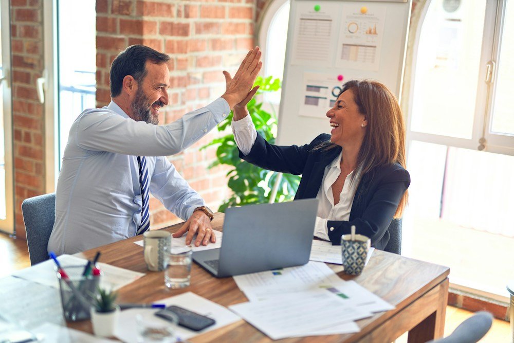 Corporate workplace team collaborating under group health benefits